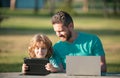 Happy father using laptop relax with schooler son holding laptop have fun together, smiling dad and little boy child Royalty Free Stock Photo