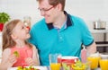 Happy father withpretty daughter having fun breakfast Royalty Free Stock Photo