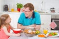 Happy father withpretty daughter having fun breakfast Royalty Free Stock Photo