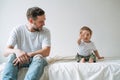 Happy father young man and baby girl little daughter having fun on bed in children room at home Royalty Free Stock Photo