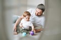 Happy father young man and baby girl little daughter having fun playing with toy in children room at home, selective focus Royalty Free Stock Photo