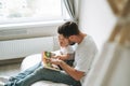 Happy father young man and baby girl little daughter having fun reading a book in children room at home Royalty Free Stock Photo