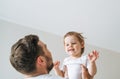 Happy father young man and baby girl little daughter having fun in children room at home Royalty Free Stock Photo