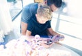 Happy father with young son using tablet PC in sunny room.Dad and little boy mobile computer resting indoor together.Horizontal Royalty Free Stock Photo