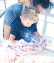 Happy father with young son using tablet PC in sunny room.Dad and little boy playing computer resting indoor together Royalty Free Stock Photo