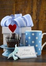 Happy Fathers Concept with blue and white gift and cupcake.