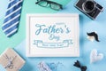 Happy Fathers Day background concept with picture frame, retro camera, decorated bowtie, necktie, eyeglasses, gift box and