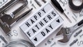 Happy Fathers Day banner concept.Working repair tools upholstery stapler,screwdriver,screws,adjustable wrench,duct tape and light Royalty Free Stock Photo