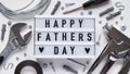 Happy Fathers Day banner concept.Working repair tools upholstery stapler,screwdriver,screws,adjustable wrench,duct tape and light Royalty Free Stock Photo