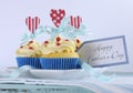 Happy Fathers Day bright and cheery red white and blue decorated cupcakes with heart toppers and gift tag Royalty Free Stock Photo