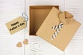 Opened Fathers Day shirt and tie gift box with tag over white wood Royalty Free Stock Photo
