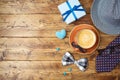 Happy Fathers day concept with coffee cup, mustache, hat, necktie and gift box on wooden table. Top view from above Royalty Free Stock Photo