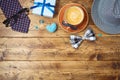Happy Fathers day concept with coffee cup, mustache, hat, necktie and gift box on wooden table. Top view from above Royalty Free Stock Photo
