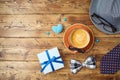 Happy Fathers day concept with coffee cup, mustache, hat, necktie and gift box on wooden table. Top view from above Royalty Free Stock Photo