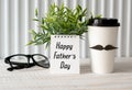 Happy fathers day concept. coffee cup with paper, heart tag with Happy father\'s day text and notebook Royalty Free Stock Photo