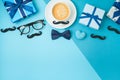 Happy Fathers day concept with coffee cup,  tie bow and gift box on blue background Royalty Free Stock Photo