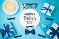 Happy Fathers day concept with coffee cup,  tie bow and gift box on blue background Royalty Free Stock Photo