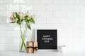 Happy Fathers day concept. Letterboard with text Happy Father`s Day, gift box, cup of coffee, buquet of flowers on table. Tile on Royalty Free Stock Photo