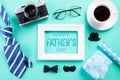 Happy fathers day concept. Top view of blue tie, beautiful gift box, black coffee cup, white picture frame with Happy father`s da Royalty Free Stock Photo