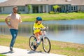 Happy fathers day. Father and son learning to ride a bicycle having fun together at Fathers day. Father teaching his son Royalty Free Stock Photo