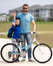 Happy fathers day. Father teaching son cycling on bike. Father learn little son to ride a bicycle. Father support and Royalty Free Stock Photo