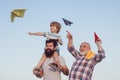 Happy fathers day. Happy grandfather father and grandson with toy paper airplane over blue sky and clouds background