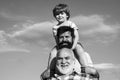 Happy fathers day. Grandfather playtime. Young boy with father and grandfather enjoying together in park on blue sky