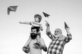 Happy fathers day. Happy grandfather father and grandson with toy paper airplane over blue sky and clouds background Royalty Free Stock Photo