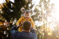 Happy fathers day. Joyful dad throws up his little smiling daughter at autumn park. Single daddy and child have fun Royalty Free Stock Photo