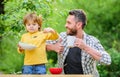 Happy fathers day. Little boy with dad eat cereal. son and father eating outdoor. Morning breakfast. Family bonds