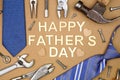 Happy Fathers Day message with frame of ties and and tools over brown paper Royalty Free Stock Photo