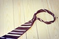 Happy Fathers Day with red, gray and black striped necktie on pine wood background in vintage style Royalty Free Stock Photo