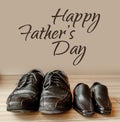 Happy fathers day, fathers shoes and baby boys shoes overhead, flat lay Royalty Free Stock Photo