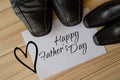 Happy fathers day, fathers shoes and baby boys shoes overhead, flat lay Royalty Free Stock Photo