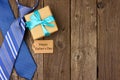 Happy Fathers Day side border with gift tag, gift and ties on rustic wood Royalty Free Stock Photo