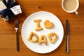 Happy Fathers Day table setting concept. Father`s Day brunch with homemade bakery I love Dad on plate, gift box, cup of coffee on Royalty Free Stock Photo