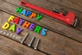 Happy fathers day text and pipe wrench on table Royalty Free Stock Photo