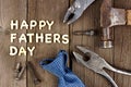 Happy Fathers Day wood letter greeting with tools and tie