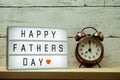 Happy Fathers Day word on light box and alarm clock Royalty Free Stock Photo