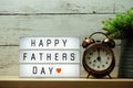 Happy Fathers Day word on light box and alarm clock Royalty Free Stock Photo