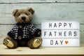 Happy Fathers Day word on light box with teddy bear Royalty Free Stock Photo