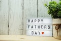 Happy Fathers Day text on light box on wooden background Royalty Free Stock Photo