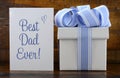 Happy Fathers Gift with blue and white gift on wood background. Royalty Free Stock Photo