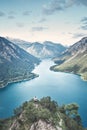 Woman on top of mountain near lake