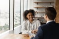 Happy female african american candidate shaking hands with male employer. Royalty Free Stock Photo