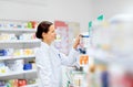 Happy female apothecary with drug at pharmacy Royalty Free Stock Photo