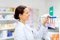 Happy female apothecary with drug at pharmacy Royalty Free Stock Photo