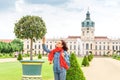 Female asian tourist in the baroque garden in front of the ancient architecture of royal Charlottenburg palace. Sightseeing