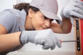 happy female builder using screwdriver on door Royalty Free Stock Photo