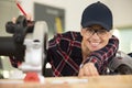 happy female carpenter using circular saw Royalty Free Stock Photo